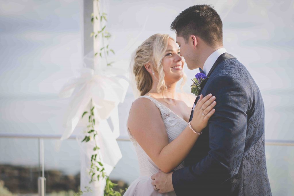 Sandringham beach Wedding photography at Sandringam Yacht club in Melbourne. A couple look into each others eyes
